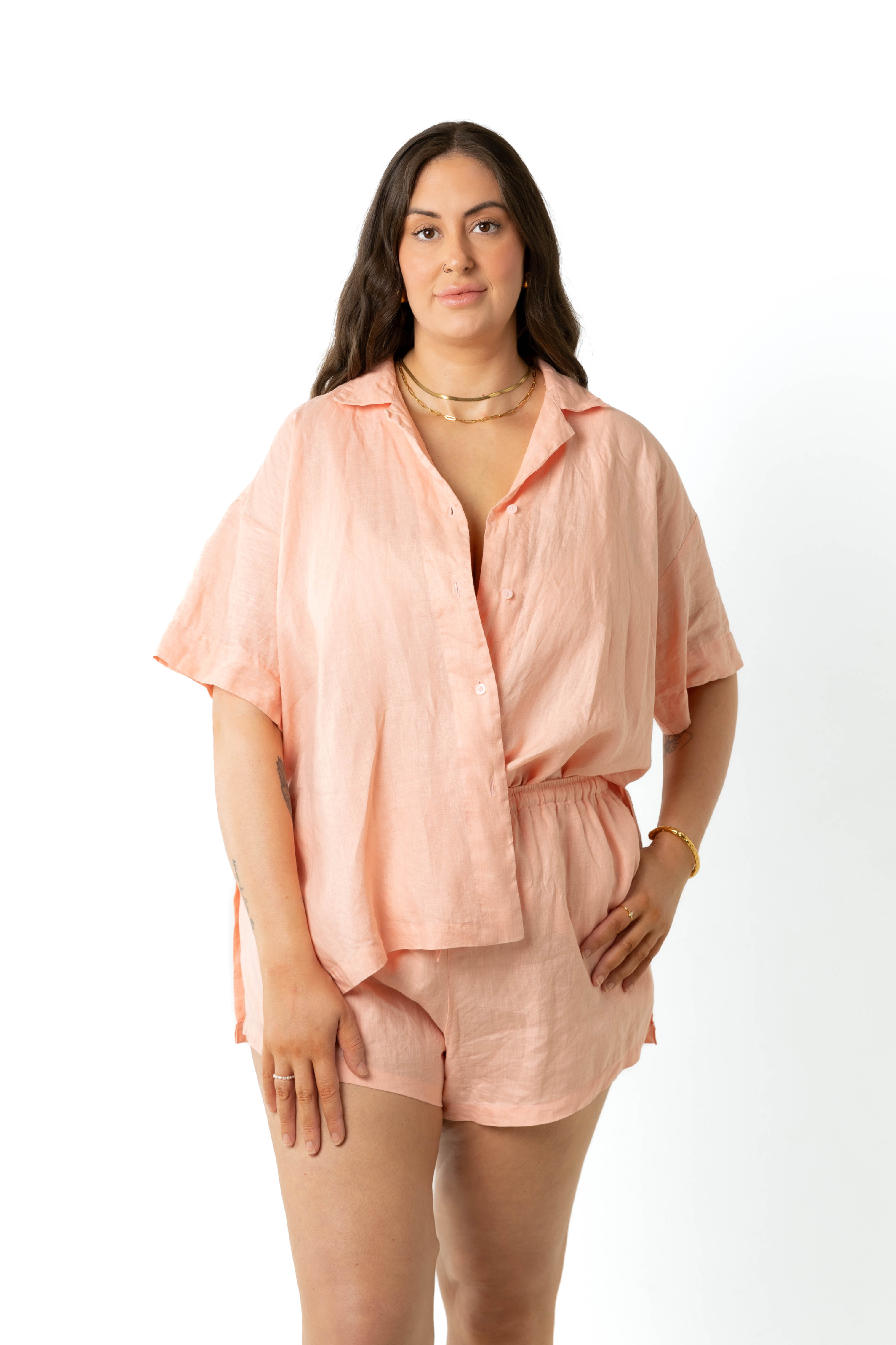 model wears size 18/20Klum peach organic linen shirt and shorts set size inclusive, tucked in