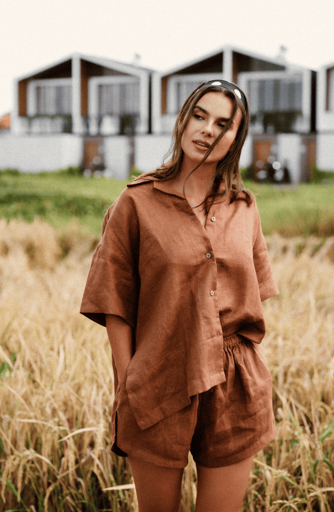 model wears matching espresso brown linen short and shorts set in the rice fields of Bali