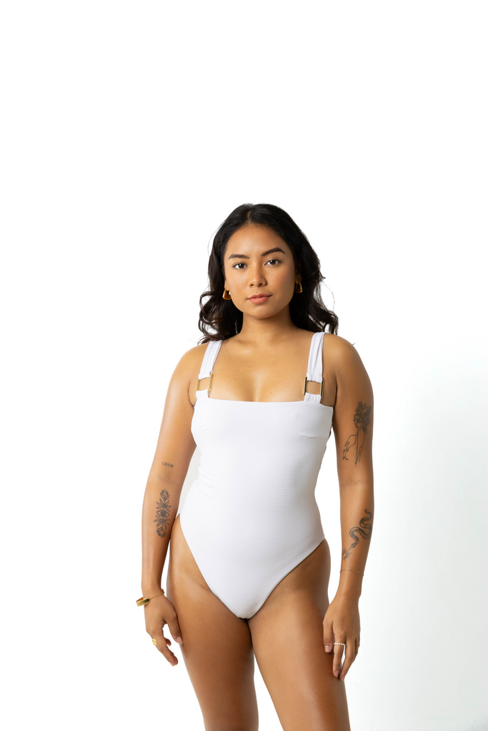 model wears size 6 womens full coverage and adjustable white one piece swimsuit, studio shoot, front shot 