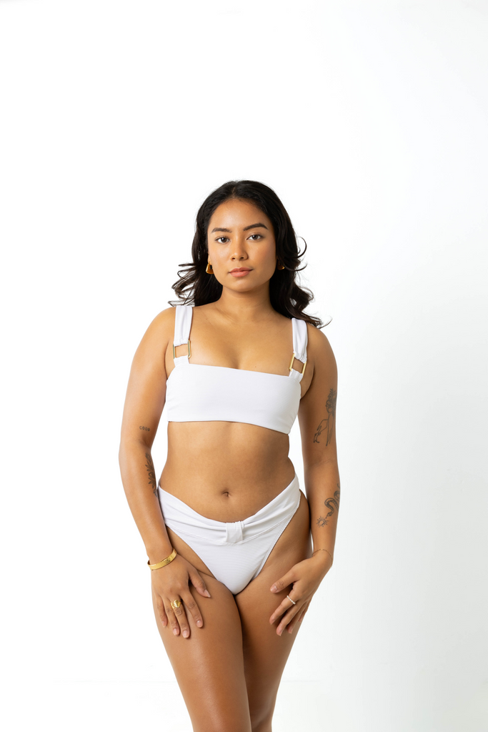 size 6 model wears cheeky high-cut leg white bikini bottoms facing front to camera