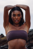 Front view of woman wearing a size XS bandage bikini top at beach.